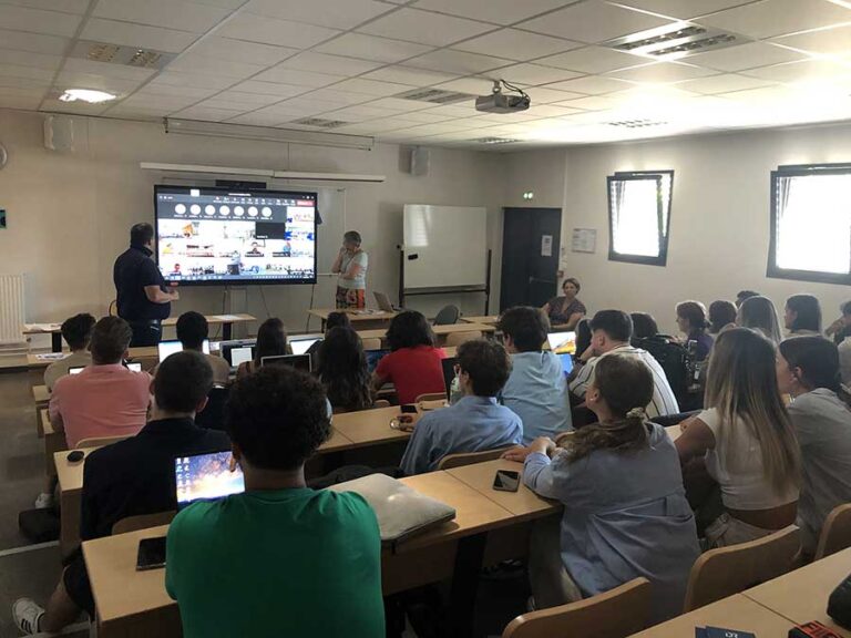 Des étudiants participent à une séance de cours en salle.